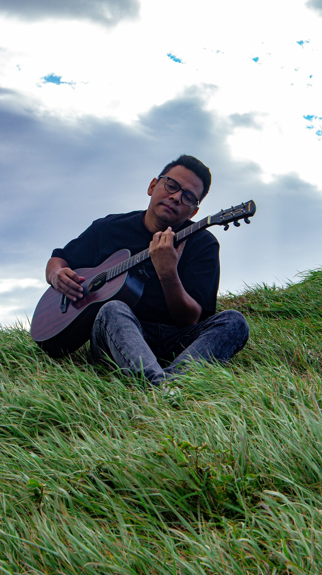 musician playing guitar outdoors